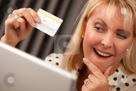 To use this stock image in your creative project, please select the size you need over to the right and click the "Add to Cart" button.
Your downloaded image will come with the Cutcaster watermark removed so don’t worry about the watermark you see on this page. Beautiful Woman Using Laptop Holding Her Credit Card stock photo, Beautiful Woman on Her Laptop Holding Her Credit Card. by Andy Dean