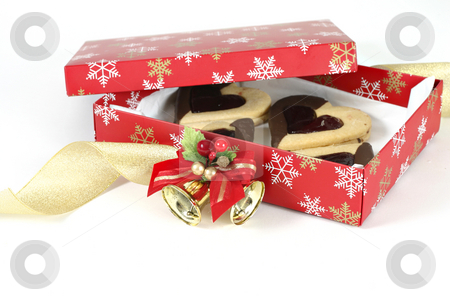 To use this stock image in your creative project, please select the size you need over to the right and click the "Add to Cart" button.
Your downloaded image will come with the Cutcaster watermark removed so don’t worry about the watermark you see on this page. Christmas Box stock photo, A box filled with shortbread hearts. Curling ribbon and bell decoration adorned box. by Leah-Anne Thompson