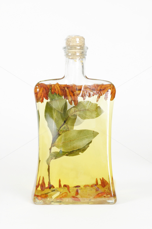 To use this stock image in your creative project, please select the size you need over to the right and click the "Add to Cart" button.
Your downloaded image will come with the Cutcaster watermark removed so don’t worry about the watermark you see on this page. Oil bottle stock photo, A glass bottle filled with grapeseed oil, garlic, chilli peppers and bay leaves. by Leah-Anne Thompson