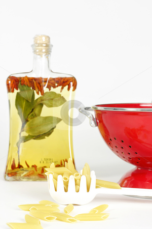 To use this stock image in your creative project, please select the size you need over to the right and click the "Add to Cart" button.
Your downloaded image will come with the Cutcaster watermark removed so don’t worry about the watermark you see on this page. Food Ingredients stock photo, An oil bottle filled with chilli, garlic, bay leaves, a colander with dry penne and a spoon in foreground. Focus on the spoon filled pasta. by Leah-Anne Thompson