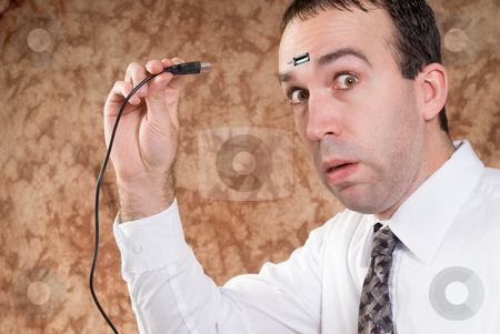 To use this stock image in your creative project, please select the size you need over to the right and click the "Add to Cart" button.
Your downloaded image will come with the Cutcaster watermark removed so don’t worry about the watermark you see on this page. Data Transfer stock photo, A man about to plug a USB cable into his forhead to transfer data by Richard Nelson