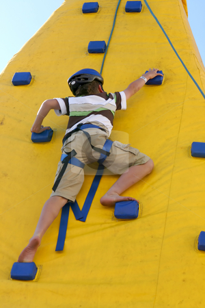 To use this stock image in your creative project, please select the size you need over to the right and click the "Add to Cart" button.
Your downloaded image will come with the Cutcaster watermark removed so don’t worry about the watermark you see on this page. Boy climbing a climbing wall. stock photo, A young agile child climbs a wall. Some slight movement. by Leah-Anne Thompson