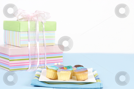 To use this stock image in your creative project, please select the size you need over to the right and click the "Add to Cart" button.
Your downloaded image will come with the Cutcaster watermark removed so don’t worry about the watermark you see on this page. Little cakes sitting on a white plate stock photo, Miniature cakes sitting on a white plate on a blue tablecloth. Pastel boxes tied with pale pink satin and gauze ribbon in backgound. Focus is to the foreground and cakes only. Space for a message. by Leah-Anne Thompson