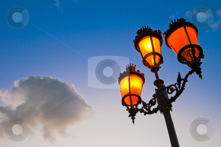 To use this stock image in your creative project, please select the size you need over to the right and click the "Add to Cart" button.
Your downloaded image will come with the Cutcaster watermark removed so don’t worry about the watermark you see on this page. Streetlamp stock photo, One of the many streetlamps located at es Born Square, Ciutadella, Minorca Island. by Anibal Trejo