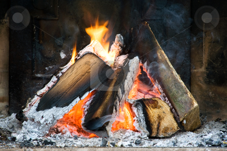 To use this stock image in your creative project, please select the size you need over to the right and click the "Add to Cart" button.
Your downloaded image will come with the Cutcaster watermark removed so don’t worry about the watermark you see on this page. Fireplace stock photo, Several logs burning in a small fireplace surrounded by ashes, smoke and flames by Corepics VOF