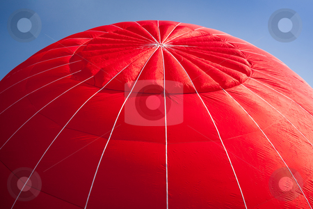 To use this stock image in your creative project, please select the size you need over to the right and click the "Add to Cart" button.
Your downloaded image will come with the Cutcaster watermark removed so don’t worry about the watermark you see on this page. Hot air balloon - red stock photo, Red canopy of hot air balloon being inflated against a bright blue sky by Steven Heap