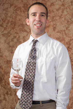 To use this stock image in your creative project, please select the size you need over to the right and click the "Add to Cart" button.
Your downloaded image will come with the Cutcaster watermark removed so don’t worry about the watermark you see on this page. Business Man Holding Wine Glass stock photo, A businessman wearing a white shirt and tie is holding a wine glass with a message saying I love you by Richard Nelson