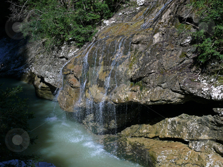 To use this stock image in your creative project, please select the size you need over to the right and click the "Add to Cart" button.
Your downloaded image will come with the Cutcaster watermark removed so don’t worry about the watermark you see on this page. Wood stream stock photo, The wood stream runs into waters of mountain small river by Vadim Tsyba