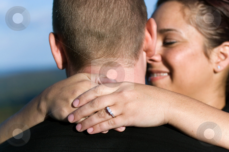 To use this stock image in your creative project, please select the size you need over to the right and click the "Add to Cart" button.
Your downloaded image will come with the Cutcaster watermark removed so don’t worry about the watermark you see on this page. Engaged Couple stock photo, A young happy couple that just got engaged. Shallow depth of field with focus on the diamond engagement ring. by Todd Arena
