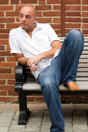 To use this stock image in your creative project, please select the size you need over to the right and click the "Add to Cart" button.
Your downloaded image will come with the Cutcaster watermark removed so don’t worry about the watermark you see on this page. Casual Guy stock photo, A man in his twenties sitting casually on a bench in an urban area. by Todd Arena