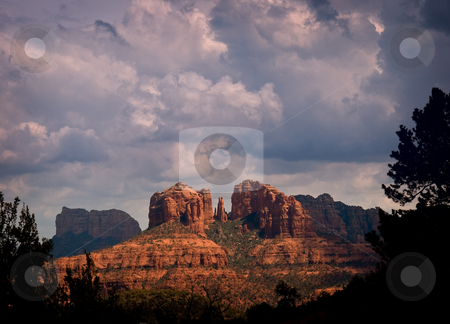 To use this stock image in your creative project, please select the size you need over to the right and click the "Add to Cart" button.
Your downloaded image will come with the Cutcaster watermark removed so don’t worry about the watermark you see on this page. Sunlit rocks in Sedona stock photo, Sedona rocks brilliantly lit by the sun in front of heavy storm clouds by Steven Heap