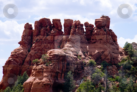 To use this stock image in your creative project, please select the size you need over to the right and click the "Add to Cart" button.
Your downloaded image will come with the Cutcaster watermark removed so don’t worry about the watermark you see on this page. Rock Formations of Sedona stock photo, Red rocks of Sedona against a bright blue sky by Steven Heap