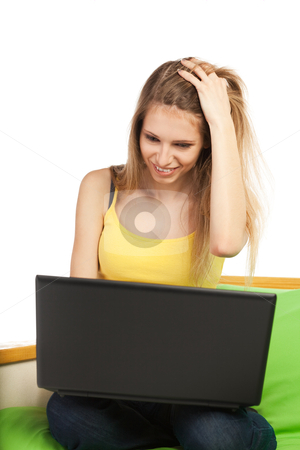 To use this stock image in your creative project, please select the size you need over to the right and click the "Add to Cart" button.
Your downloaded image will come with the Cutcaster watermark removed so don’t worry about the watermark you see on this page. Young blond woman with computer stock photo, Young blond pretty woman sitting on sofa with laptop computer; isolated on white by Mikhail Lavrenov