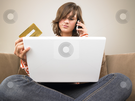 To use this stock image in your creative project, please select the size you need over to the right and click the "Add to Cart" button.
Your downloaded image will come with the Cutcaster watermark removed so don’t worry about the watermark you see on this page. Young Woman With Laptop, Shopping Via Phone stock photo, Young woman with laptop, holding credit card and talking on the phone. Vertically framed shot. by Mog Ddl