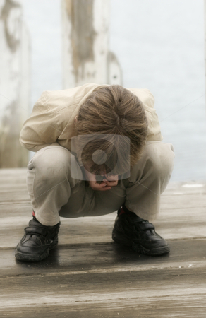 To use this stock image in your creative project, please select the size you need over to the right and click the "Add to Cart" button.
Your downloaded image will come with the Cutcaster watermark removed so don’t worry about the watermark you see on this page. A young boy's fascination stock photo, A young child looking through cracks spaces in a wooden deck pier by Leah-Anne Thompson