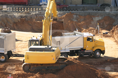 To use this stock image in your creative project, please select the size you need over to the right and click the "Add to Cart" button.
Your downloaded image will come with the Cutcaster watermark removed so don’t worry about the watermark you see on this page. Construction Industry in progress stock photo, Filling a dump truck with dirt on a construction site. by Leah-Anne Thompson