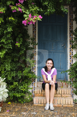 To use this stock image in your creative project, please select the size you need over to the right and click the "Add to Cart" button.
Your downloaded image will come with the Cutcaster watermark removed so don’t worry about the watermark you see on this page. Young girl sitting on steps stock photo, A young girl wearing sporty clothes sitting on steps with a blue door behind her. Photo taken on the 30th of September, 2009. by Alessandro Rizzolli