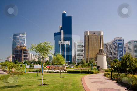 To use this stock image in your creative project, please select the size you need over to the right and click the "Add to Cart" button.
Your downloaded image will come with the Cutcaster watermark removed so don’t worry about the watermark you see on this page. Abu Dhabi Skyline with lighthouse stock photo, View of Abu Dhabi Skyline with gardens and small lighthouse in foreground by Steven Heap