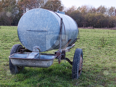 To use this stock image in your creative project, please select the size you need over to the right and click the "Add to Cart" button.
Your downloaded image will come with the Cutcaster watermark removed so don’t worry about the watermark you see on this page. Water container stock photo, Metal water container in a countryside meadow by Laurent Dambies