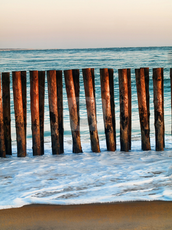 To use this stock image in your creative project, please select the size you need over to the right and click the "Add to Cart" button.
Your downloaded image will come with the Cutcaster watermark removed so don’t worry about the watermark you see on this page. Beach shore stock photo, Atlantic ocean beach shore with wooden barrier by Laurent Dambies