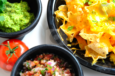 To use this stock image in your creative project, please select the size you need over to the right and click the "Add to Cart" button.
Your downloaded image will come with the Cutcaster watermark removed so don’t worry about the watermark you see on this page. Nachos and Toppings stock photo, Top view of cheese Nachos with tomato salsa and fresh guacamole by Lynn Bendickson