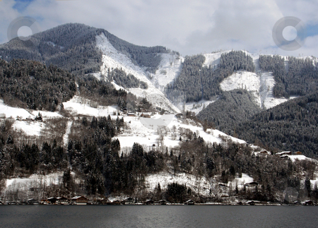 To use this stock image in your creative project, please select the size you need over to the right and click the "Add to Cart" button.
Your downloaded image will come with the Cutcaster watermark removed so don’t worry about the watermark you see on this page. Alpine lake and mountains stock photo, Scenic view of alpine lake and forested mountains in winter, Zell am Zee resort, Austria. by Martin Crowdy