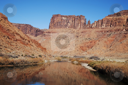 To use this stock image in your creative project, please select the size you need over to the right and click the "Add to Cart" button.
Your downloaded image will come with the Cutcaster watermark removed so don’t worry about the watermark you see on this page. Canyonlands National Park stock photo, View of the red rock formations in Canyonlands National Park with blue sky by Mark Smith