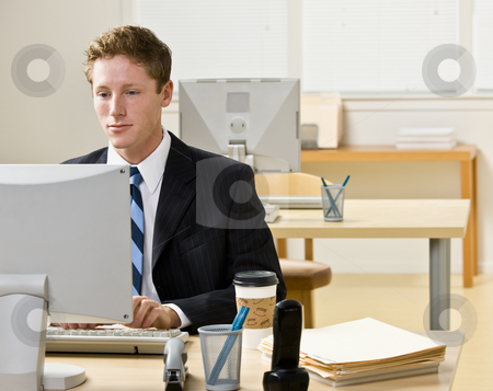 To use this stock image in your creative project, please select the size you need over to the right and click the "Add to Cart" button.
Your downloaded image will come with the Cutcaster watermark removed so don’t worry about the watermark you see on this page. Businessman working on computer stock photo, Businessman working on computer by Jonathan Ross