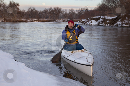 To use this stock image in your creative project, please select the size you need over to the right and click the "Add to Cart" button.
Your downloaded image will come with the Cutcaster watermark removed so don’t worry about the watermark you see on this page. Paddling canoe on a winter river stock photo, Mature male paddling a decked expedition canoe on river in winter scenery (South Platte in eastern Colorado) by Marek Uliasz
