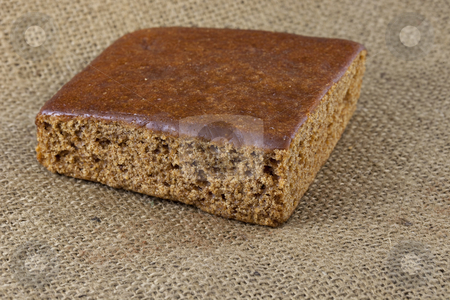 To use this stock image in your creative project, please select the size you need over to the right and click the "Add to Cart" button.
Your downloaded image will come with the Cutcaster watermark removed so don’t worry about the watermark you see on this page. Gingerbread cake stock photo, A piece of gingerbread cake on burlap canvas by Marek Uliasz