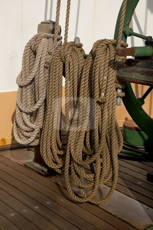 To use this stock image in your creative project, please select the size you need over to the right and click the "Add to Cart" button.
Your downloaded image will come with the Cutcaster watermark removed so don’t worry about the watermark you see on this page. Coiled ropes and winch stock photo, Three coils of rope on a deck of sailing ship next to winch used rise sails by Marek Uliasz