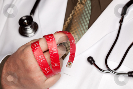 To use this stock image in your creative project, please select the size you need over to the right and click the "Add to Cart" button.
Your downloaded image will come with the Cutcaster watermark removed so don’t worry about the watermark you see on this page. Doctor with Stethoscope Holding Measuring Tape stock photo, Doctor with Stethoscope Holding Red Measuring Tape. by Andy Dean