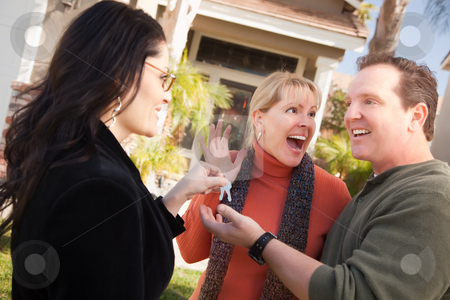 To use this stock image in your creative project, please select the size you need over to the right and click the "Add to Cart" button.
Your downloaded image will come with the Cutcaster watermark removed so don’t worry about the watermark you see on this page. Hispanic Female Real Estate Agent Handing Keys to Excited Couple stock photo, Hispanic Female Real Estate Agent Handing Over New House Keys to Excited Couple. by Andy Dean
