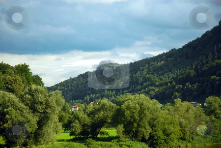 To use this stock image in your creative project, please select the size you need over to the right and click the "Add to Cart" button.
Your downloaded image will come with the Cutcaster watermark removed so don’t worry about the watermark you see on this page. Landscape of houses in a green mountain forest stock photo, Green mountain forest. Czech Republic by Cienpies Design