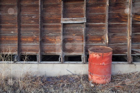 To use this stock image in your creative project, please select the size you need over to the right and click the "Add to Cart" button.
Your downloaded image will come with the Cutcaster watermark removed so don’t worry about the watermark you see on this page. Old farm scene stock photo, Old rusty oil barrel and weathered wooden barn wall by Marek Uliasz