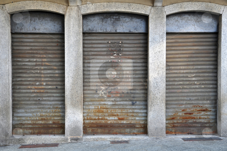 To use this stock image in your creative project, please select the size you need over to the right and click the "Add to Cart" button.
Your downloaded image will come with the Cutcaster watermark removed so don’t worry about the watermark you see on this page. Lowered rolling shutters of a disused shop stock photo, Lowered rolling shutters of a disused shop, rusty, dirty and failure cityscape by Roberto Marinello