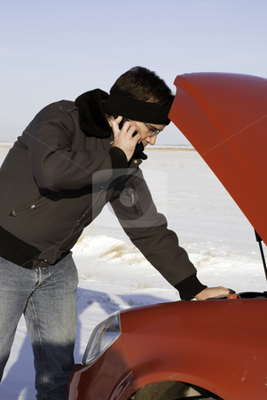 To use this stock image in your creative project, please select the size you need over to the right and click the "Add to Cart" button.
Your downloaded image will come with the Cutcaster watermark removed so don’t worry about the watermark you see on this page. Car Broken Down stock photo, A young man is checking under the car hood while talking on a cell phone. by Richard Nelson