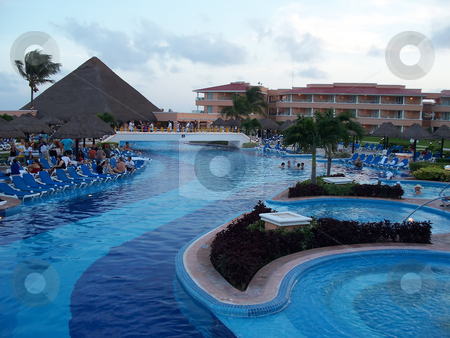 To use this stock image in your creative project, please select the size you need over to the right and click the "Add to Cart" button.
Your downloaded image will come with the Cutcaster watermark removed so don’t worry about the watermark you see on this page. Poolside stock photo, A beautiful poolside resort in Cancun Mexico by CHERYL LAFOND