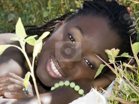 To use this stock image in your creative project, please select the size you need over to the right and click the "Add to Cart" button.
Your downloaded image will come with the Cutcaster watermark removed so don’t worry about the watermark you see on this page. Young black woman reclining portrait outdoors bare top stock photo, Young African American woman smiling outdoors portrait bare by Jeff Cleveland