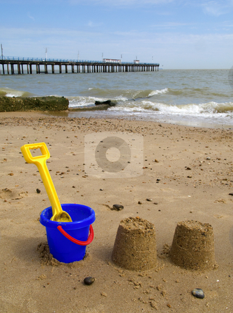 To use this stock image in your creative project, please select the size you need over to the right and click the "Add to Cart" button.
Your downloaded image will come with the Cutcaster watermark removed so don’t worry about the watermark you see on this page. Kids bucket, spade and sandcastles on Felixstowe beach. stock photo, Kids bucket, spade and sandcastles on Felixstowe beach. by Stephen Rees