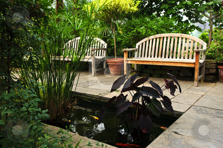 To use this stock image in your creative project, please select the size you need over to the right and click the "Add to Cart" button.
Your downloaded image will come with the Cutcaster watermark removed so don’t worry about the watermark you see on this page. Lush green garden stock photo, Lush green garden with stone landscaping, koi pond and benches by Elena Elisseeva