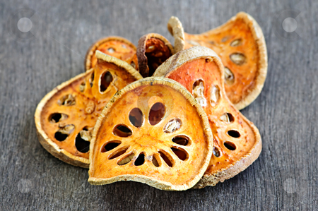 To use this stock image in your creative project, please select the size you need over to the right and click the "Add to Cart" button.
Your downloaded image will come with the Cutcaster watermark removed so don’t worry about the watermark you see on this page. Dried bael fruit stock photo, Slices of dried bael fruit on wood surface by Elena Elisseeva