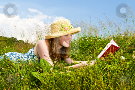 To use this stock image in your creative project, please select the size you need over to the right and click the "Add to Cart" button.
Your downloaded image will come with the Cutcaster watermark removed so don’t worry about the watermark you see on this page. Young girl reading book in meadow stock photo, Young teenage girl reading book in summer meadow with straw hat by Elena Elisseeva