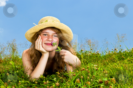 To use this stock image in your creative project, please select the size you need over to the right and click the "Add to Cart" button.
Your downloaded image will come with the Cutcaster watermark removed so don’t worry about the watermark you see on this page. Young girl laying in meadow stock photo, Young teenage girl laying in summer meadow resting chin on hand smelling flower by Elena Elisseeva