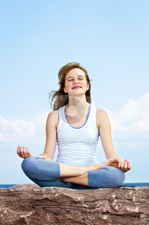 To use this stock image in your creative project, please select the size you need over to the right and click the "Add to Cart" button.
Your downloaded image will come with the Cutcaster watermark removed so don’t worry about the watermark you see on this page. Young girl meditating outdoors stock photo, Portrait of young teenage girl practicing yoga outside by Elena Elisseeva