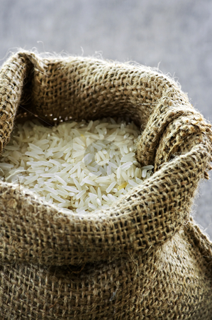 To use this stock image in your creative project, please select the size you need over to the right and click the "Add to Cart" button.
Your downloaded image will come with the Cutcaster watermark removed so don’t worry about the watermark you see on this page. Long grain rice in burlap sack stock photo, Raw long grain white rice grains in burlap bag by Elena Elisseeva