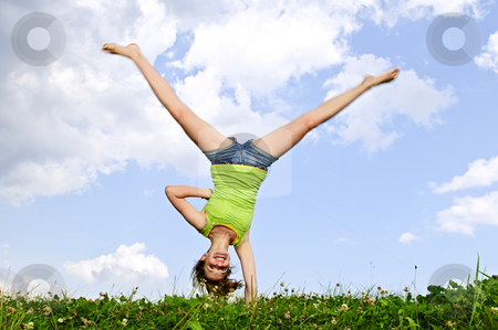 To use this stock image in your creative project, please select the size you need over to the right and click the "Add to Cart" button.
Your downloaded image will come with the Cutcaster watermark removed so don’t worry about the watermark you see on this page. Young girl doing cartwheel stock photo, Young teenage girl doing cartwheel in a summer meadow by Elena Elisseeva