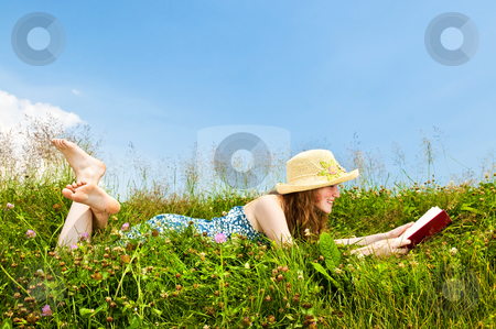 To use this stock image in your creative project, please select the size you need over to the right and click the "Add to Cart" button.
Your downloaded image will come with the Cutcaster watermark removed so don’t worry about the watermark you see on this page. Young girl reading book in meadow stock photo, Young teenage girl reading book in summer meadow with straw hat by Elena Elisseeva