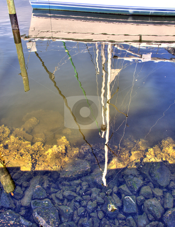To use this stock image in your creative project, please select the size you need over to the right and click the "Add to Cart" button.
Your downloaded image will come with the Cutcaster watermark removed so don’t worry about the watermark you see on this page. Reflections of sail boat stock photo, Reflections of a sail boat moored close to shore. by Steve Carroll