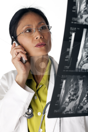 To use this stock image in your creative project, please select the size you need over to the right and click the "Add to Cart" button.
Your downloaded image will come with the Cutcaster watermark removed so don’t worry about the watermark you see on this page. Doctor Reading MRI scan stock photo, Asian female doctor looking at an MRI scan while talking on a cellphone. Vertical shot. Isolated on white. by Edward Bock